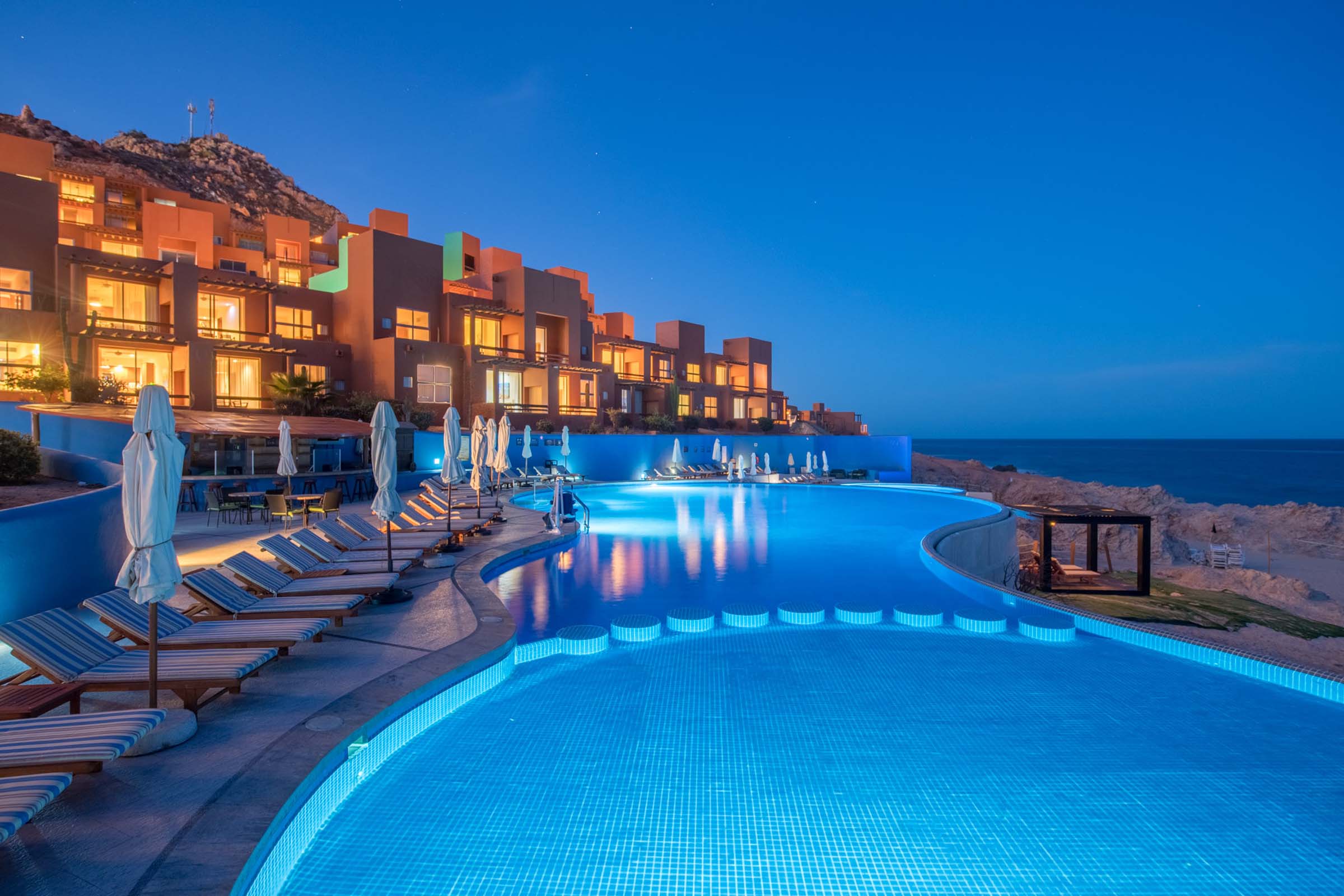 facade-of-the-hotel-club-regina-los-cabos-at-night-in-front-of-the-pool-and-the-sea